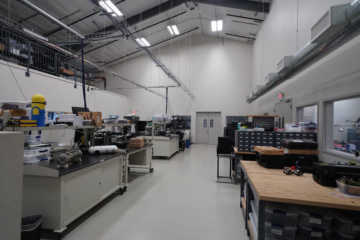 High-bay sensor integration lab with workbenches and test equipment