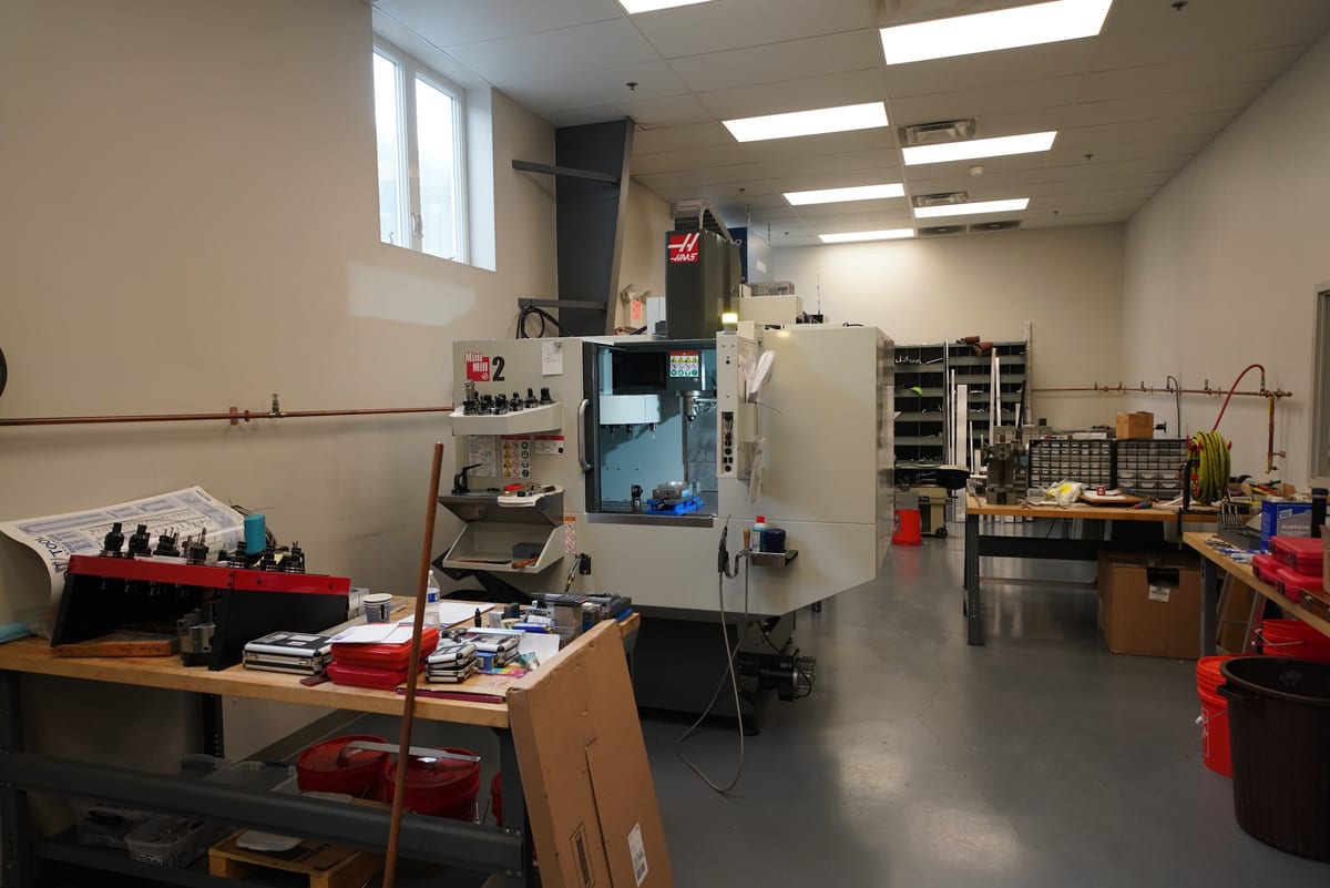 Machine shop with a CNC mill, workbenches and fabrication tools